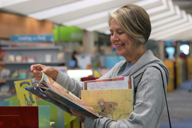 Mariane Braden reads a book at the Burton Barr Library on November 13, 2019.