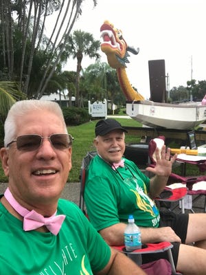 The Hell Gate Sea Dragons' boat was on display at the 2019 Making Strides Against Breast Cancer Walk in Stuart. Pictured are Jim St. Pierre, left, and Bob Wolfort, supporters of the Hell Gate Sea Dragons.