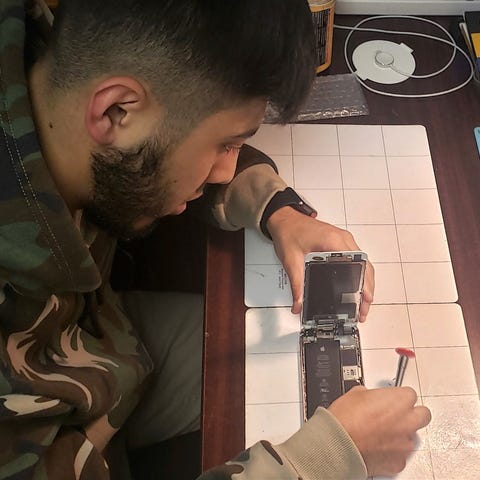 Muhammad Hoshur, 23, fixes phones and other electr