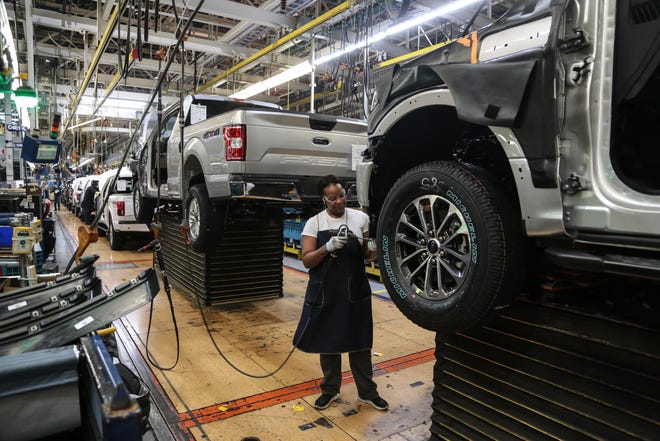 Workers work on the assembly line for the Ford F-150 trucks at the Ford Rouge Plant in Dearborn on Thursday, September 27, 2018.