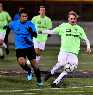 Ben Bullen of York Catholic, right, kicks the ball away from Dallastown's Gabe Wunderlich during the York-Adams League Boys' Soccer Senior All Star Game at Red Lion High School on Thursday, Nov. 14. Wunderlich was named the York-Adams Division I Player of the Year, while Bullen earned the same honor in Division III. John A. Pavoncello photo