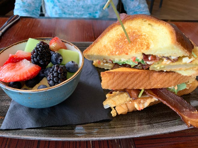 Fried green tomatoes are tucked between slices of toasted challah bread with pimento cheese, strips of smoked bacon and arugula. The Cobalt BLT came with a bright, colorful side of assorted fresh fruit.