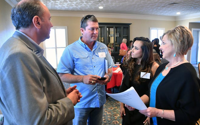Dwayne Bivona, executive director of Big Brothers Big Sisters, left, and Vanda Cullar, regional director of the Small Business Development Center at Midwestern State University, right, answer questions for celebrity dancers David Kelley and Ivonne Wineinger at the Dancing for the Stars reveal luncheon Friday at The Forum. Professional dance instructors are paired with community celebrities for the event.