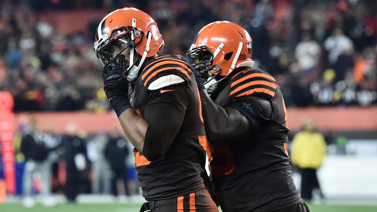 Cleveland Browns defensive tackle Devaroe Lawrence (99) leads defensive end Myles Garrett (95) off the field after a fight during the second half against the Pittsburgh Steelers at FirstEnergy Stadium.