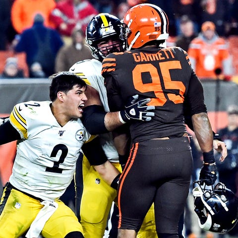 Mason Rudolph, left, reacts after being hitting in