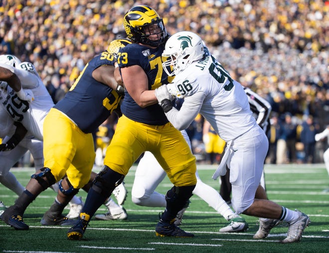 Michigan State defensive end Jacub Panasiuk tries to get past Michigan right tackle Jalen Mayfield at Michigan Stadium in Ann Arbor on Nov. 16, 2019.