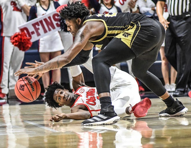 Western Michigan center Titus Wright, top, and Mississippi guard Bryce Williams (13) go for the ball.