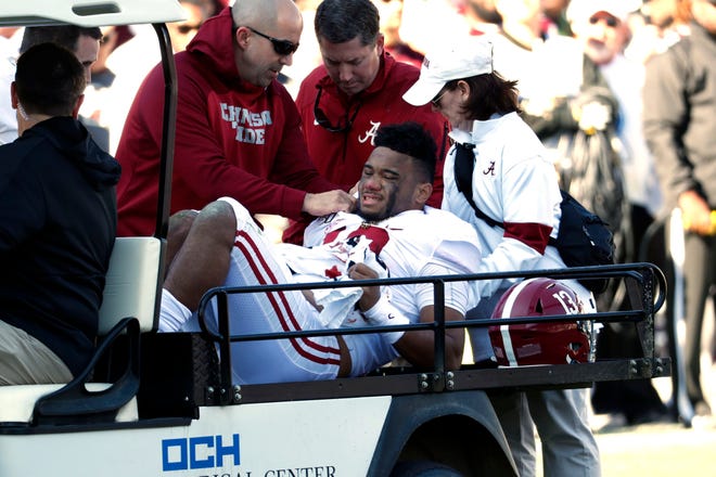 Alabama quarterback Tua Tagovailoa (13) is carted off the field after getting injured in the first half on Saturday.