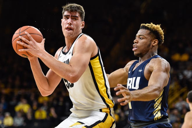 Iowa center Luka Garza controls the ball as Oral Roberts forward Elijah Lufile defends during the first half at Carver-Hawkeye Arena on Friday.