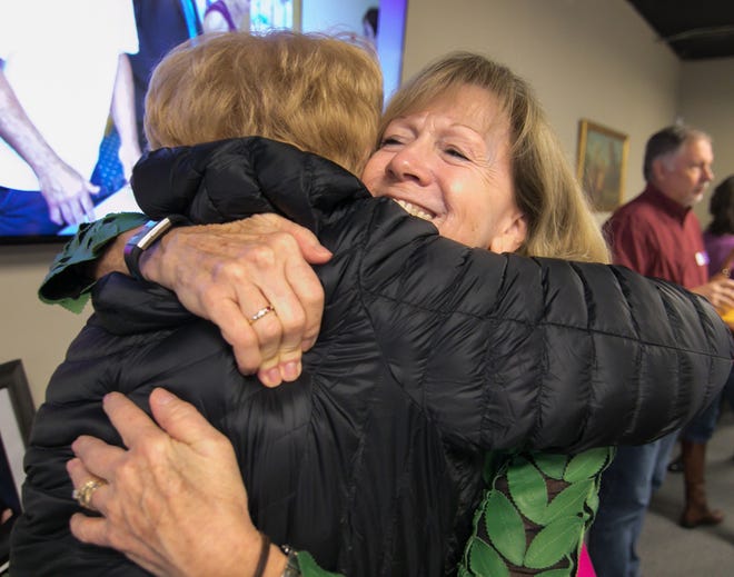Katherine Janego gets a hug from Judy Stover, a former Love, INC staff member, as Janego says farewell on her last day Friday, Nov. 15, 2019. Janego is retiring after 13 years as executive director of Love, INC.