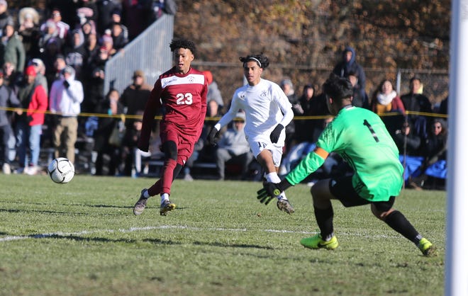 Ossining's Yohance Douglas (23) centers a pass during their 1-0 double overtime loss in the NYSPHSAA boys soccer semi-finals at Twin Towers Middle School on Saturday, November 16, 2019.