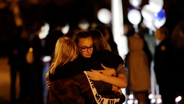 Students embrace during a vigil at Central Park in