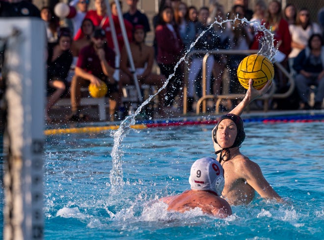 Tulare Western's Zac Schoenau looks to shoot over Mt. Whitney's Jack Hohne in a Central Section Division III boys water polo championship on Saturday, November 16, 2019.