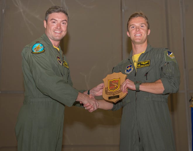 1st Lt. Daniel Brown, 314th Fighter Squadron Basic Course graduate, accepts the Red River Rat award during the graduation of B-Course Class 19-BBH, Nov. 9, 2019, on Holloman Air Force Base, N.M. Fourteen B-Course students graduated and will be reassigned to operational flying units throughout the combat Air Force.