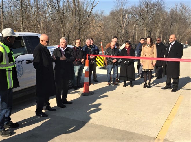 Canton Township Supervisor Pat Williams (third from left) and Wayne County Supervisor Warren Evans (second from left) spoke at the Lilley Road bridge reopening ceremony Monday, Nov. 18.