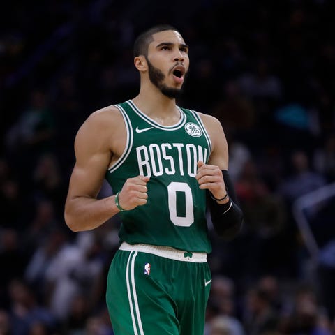 Boston Celtics' Jayson Tatum celebrates a score ag