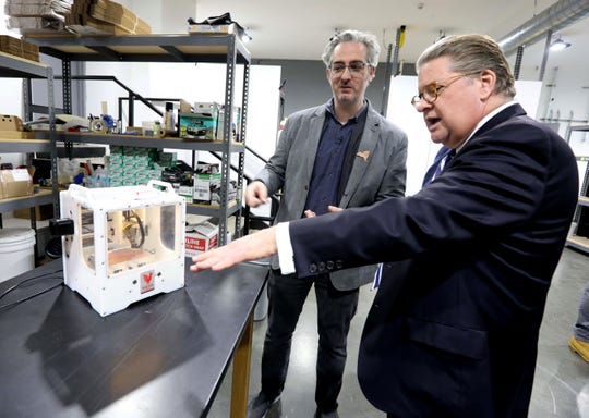Bre Pettis, left, owner of Bantam Tools, shows State Senator Pete Harckham the desktop size PCB Milling Machine that Bantam Tools will be producing at their new facility in Peekskill Nov. 18, 2019. The milling machine produces devices such as prototypes of circuit boards, and is also used for metal engraving for uses in jewelry making and other industries. The company held a grand opening ceremony Monday.
