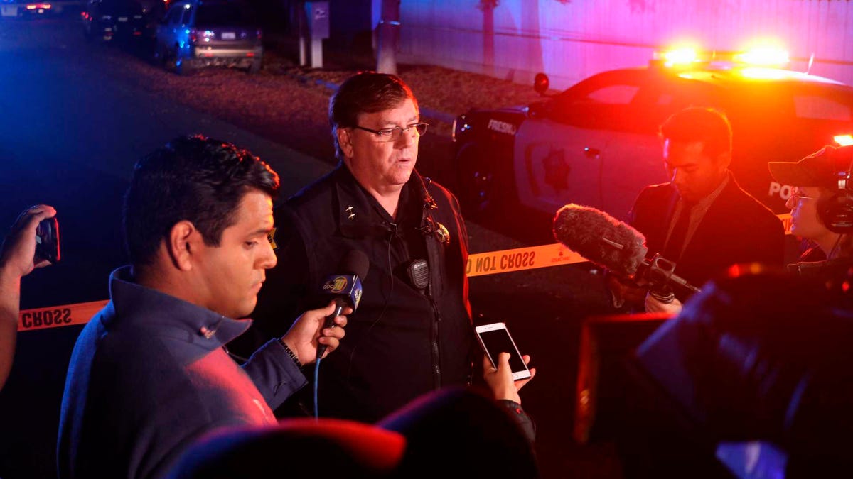 Fresno Police Lt. Bill Dooley speaks to reporters at the scene of a shooting at a backyard party Sunday, Nov. 17, 2019, in southeast Fresno, Calif. Multiple people were shot and at least four of them were killed Sunday at a party in Fresno when suspects sneaked into the backyard and fired into the crowd, police said.