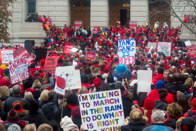Teachers and students gather in front of the Statehouse in Downtown Indianapolis, Ind., while participating in the Red for Ed Action Day rally Tuesday afternoon, Nov. 19, 2019. 