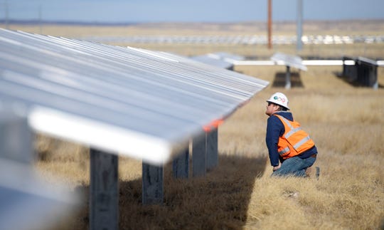 Kenny Stewart, a DEPCOM field engineer, looks at the solar panels in the Rawhide Flats Solar site in Wellington, Colo. on Tuesday, Nov. 19, 2019. 