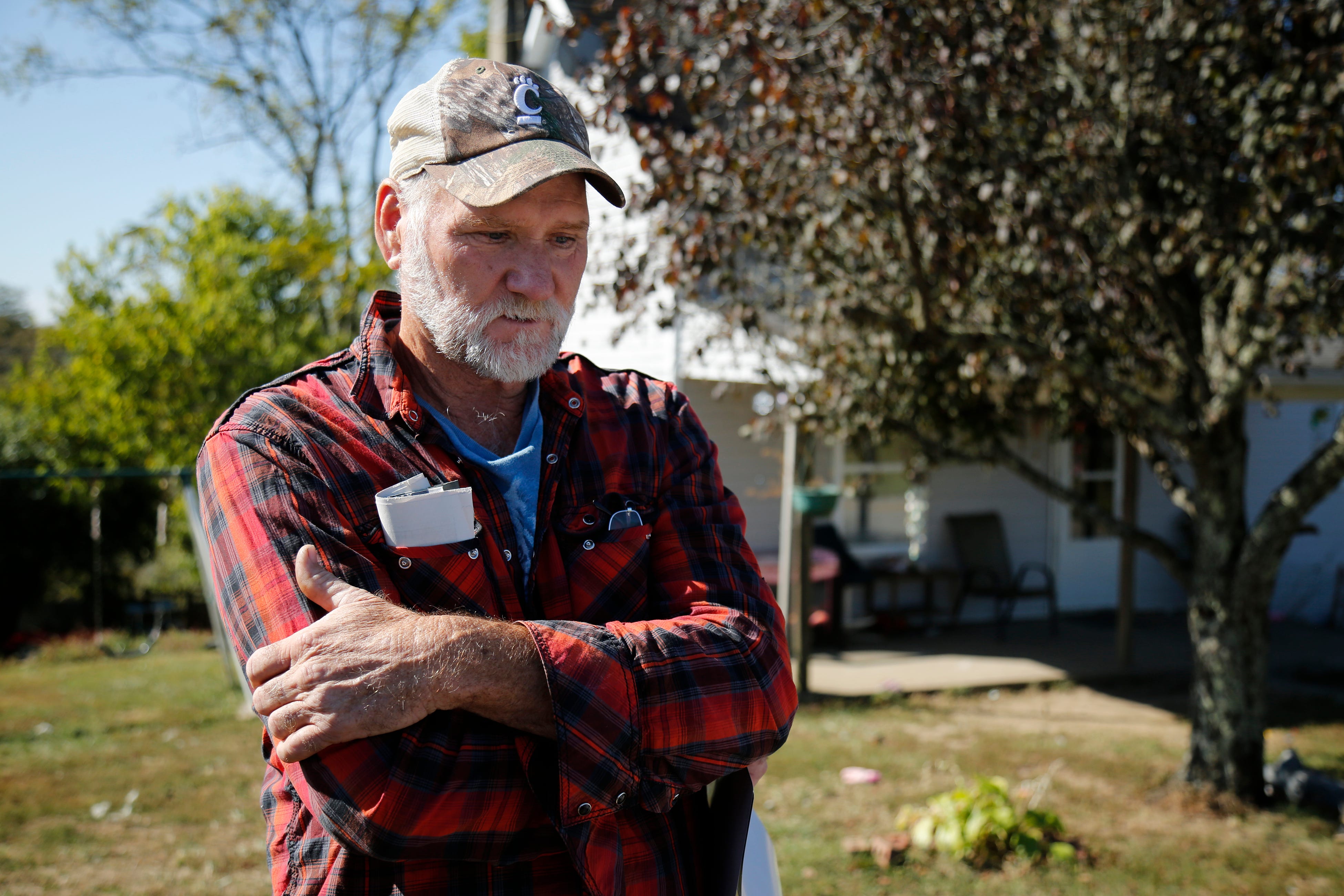 Arnold Hughes outside his home in the unincorporated town of DeMossville.  After years of manual labor, he lost his job in 2016 as his body started to break down. He’s been unable to find another job since.