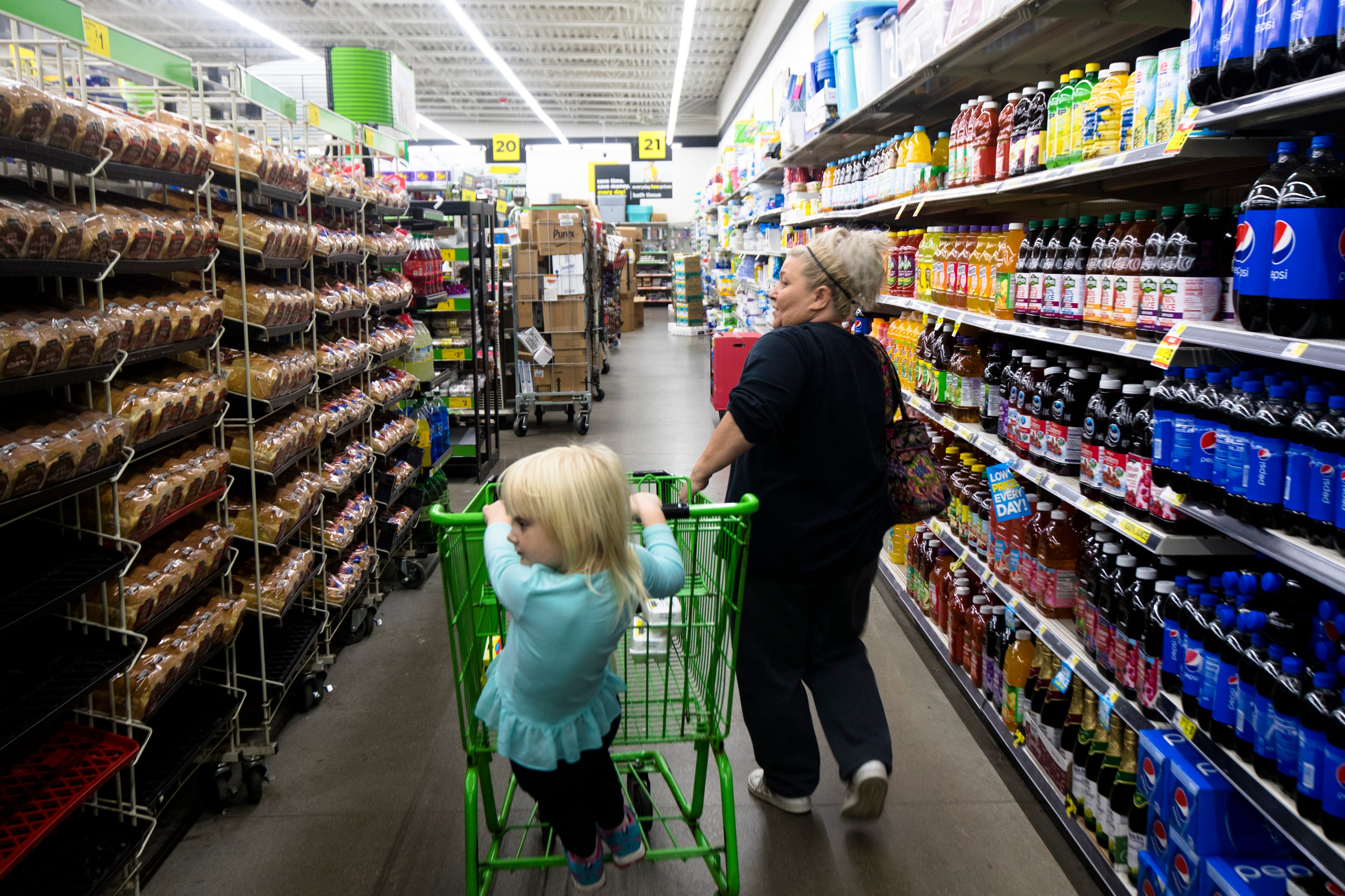 Tonya Sims shops with her granddaughter, Sophia Allen, 4, in the bread aisle of a Dollar General Market store in Falmouth. Dollar General is one of two grocery stores in Falmouth.