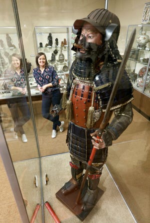 Jennifer Bush is the director of the Johnson-Humrickhouse Museum in Coshocton. She is pictured with the museum’s Japanese Samurai armor.