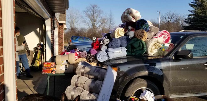 Menomonee Falls native Charlie “Bud” Lomas and his wife, Patti, are honoring their son, CJ. by collecting socks and hats for Street Angels Milwaukee Outreach.
