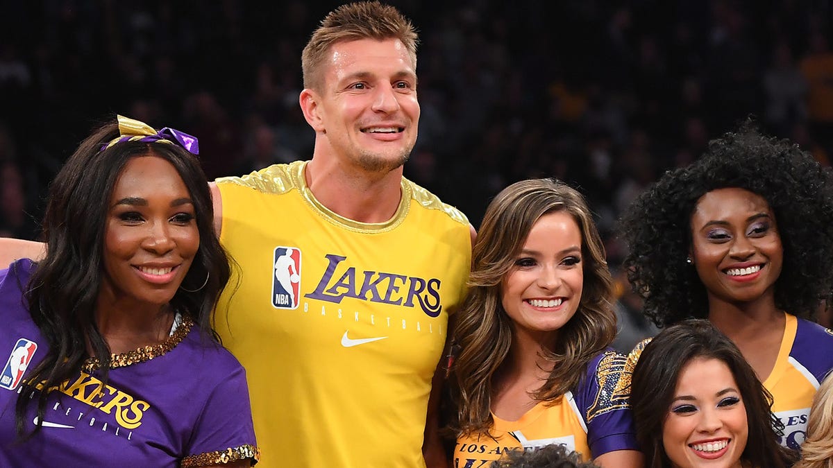 Venus Williams, former NFL player Rob Gronkowski and comedians James Corden and Ian Karmel take a photo with the Los Angeles Lakers girls after dancing with them during halftime on Nov. 19.