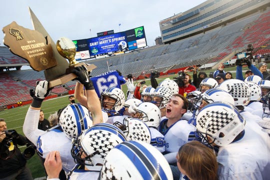 St. Mary's Springs players hoist the championship trophy after the WIAA Division 6 state championship game Nov. 21, 2019, at Camp Randall Stadium in Madison.
