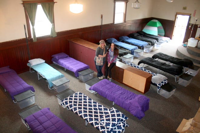 Silverton Sheltering Service's executive director Hilary Dumitrescu and shelter manager Julia Marshall rest between last-minute preparations as they and other volunteers ready the new upstairs space at Oak Street Church for its 2019-20 season. The 30-bed shelter is open November through March, 8 p.m. to 8 a.m.