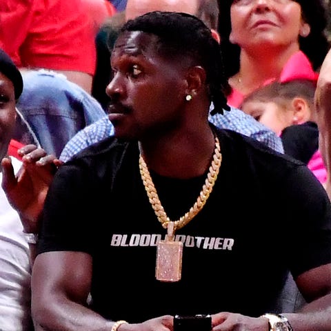 Antonio Brown is seen sitting courtside at a Grizz