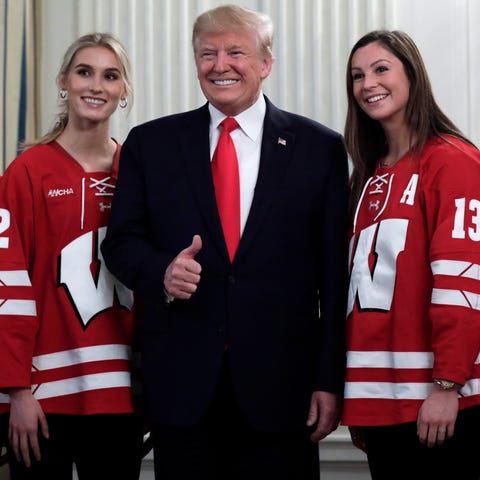 President Donald J. Trump (C) poses with athletes 