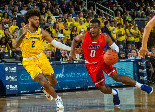 Michigan forward Isaiah Livers (2) defends against Houston Baptist guard Ian DuBose (0) during the first half of an NCAA college basketball game in Ann Arbor on Nov. 22, 2019.