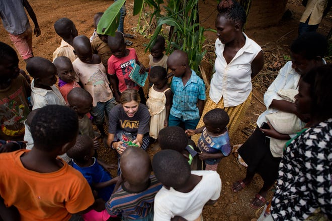 Claire Pothier talks to a group of children and mothers in Uganda