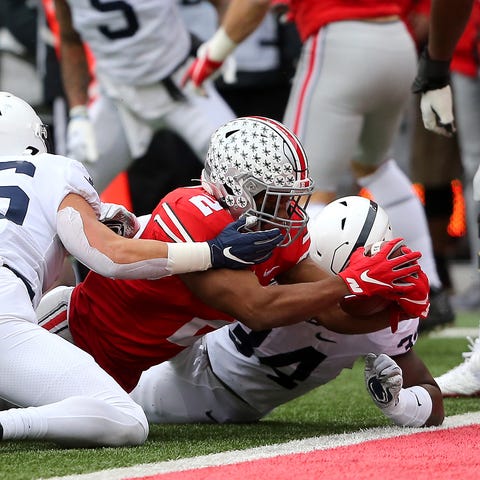 Ohio State running back J.K. Dobbins dives into th