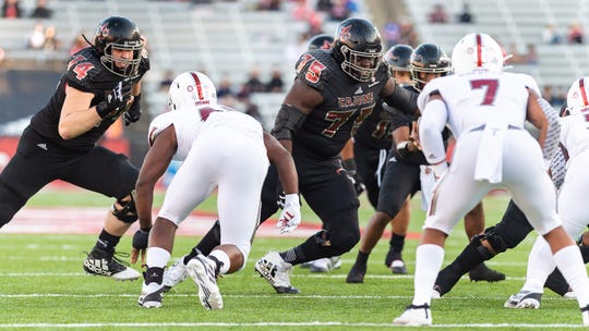 UL All-American offensive lineman Kevin Dotson (75), a 2020 NFL Draft prospect, blocks during a November game against Troy at Cajun Field.