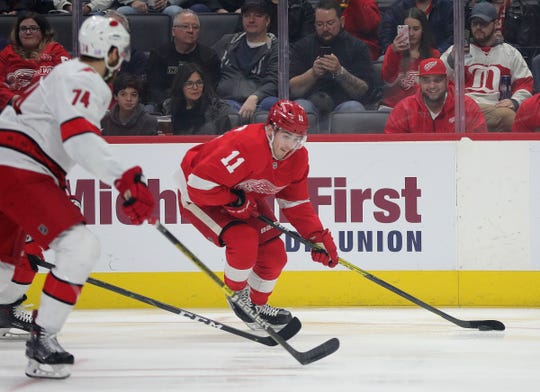 Latest Sports News: Red Wings right wing Filip Zadina skates against Hurricanes defenseman Jaccob Slavin during the first period of the Wings' 2-0 loss on Sunday, Nov. 24, 2019, at Little Caesars Arena.