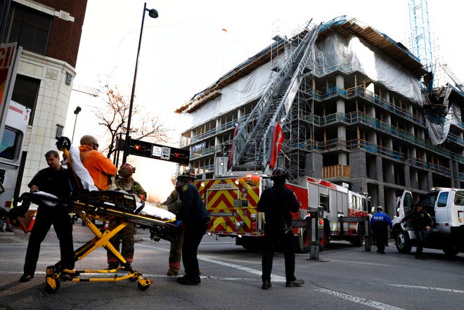 Emergency crews transport a construction worker injured at a partial building collapse in Cincinnati, Ohio, Monday, Nov. 25, 2019.