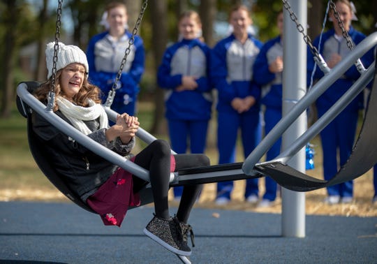Kammy Hiner, 17, attends a ceremony for a new "inclusive" swing at the Roy G. Holland Memorial Park in Fishers. Kammy has Wolf-Hirschhorn syndrome.