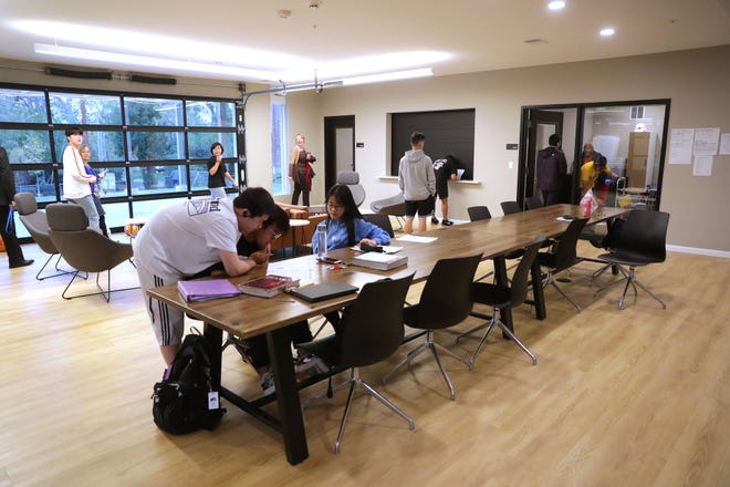 Wisconsin Lutheran High School international students work on homework in the common area of their dormitory, Honey Creek Hall, in 2019.