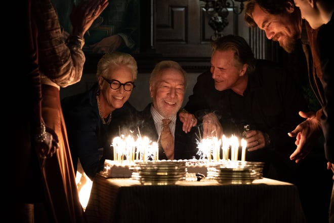 Wealthy mystery writer Harlan Thrombey (Christopher Plummer, center) celebrates his birthday with family members (Jamie Lee Curtis, Don Johnson and Michael Shannon) before turning up dead in 'Knives Out.'