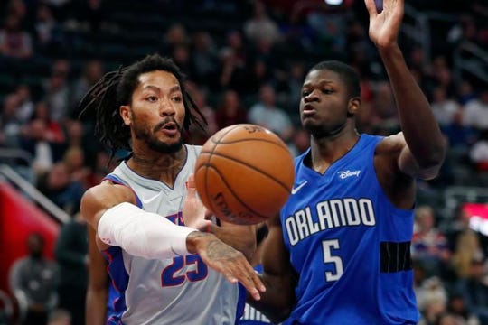 Pistons guard Derrick Rose, left, passes against Magic center Mo Bamba during the first half on Monday at Little Caesars Arena.