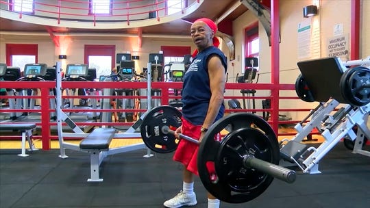 This photo, provided by 13 WHAM-TV on Monday Nov. 25, 2019, shows Willie Murphy, 82, as she lifts weights at a gym in Rochester, N.Y.