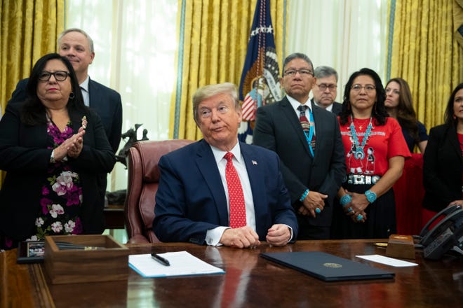 President Donald Trump listens to a question during an event to sign an executive order establishing the Task Force on Missing and Murdered American Indians and Alaska Natives in the Oval Office of the White House on Tuesday.