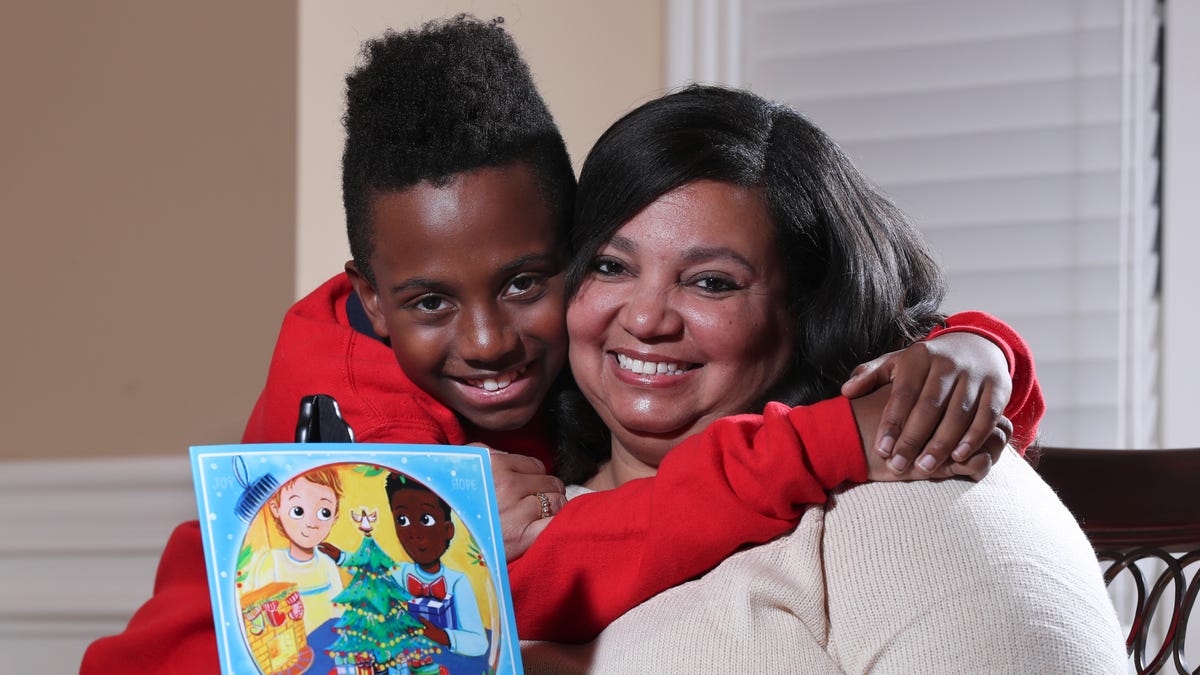Deedee Cummings, right, with her son Nick Cummings, 11, at their home in Louisville, Ky. on Nov. 25, 2019.  Cummings was concerned that there are not many holiday books featuring people of color so she wrote a holiday book inspired by him called "In the Nick of Time."