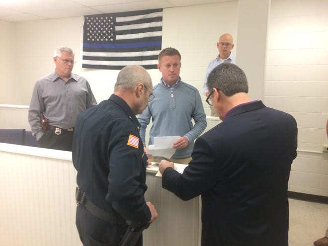 Justin Scheiben (center) and John Meredith (right) present an $8,000 check to Richmond Police Chief Jim Branum for the Blue Angels Fund as Lt. Donnie Benedict and Detective Neal VanMiddlesworth watch.