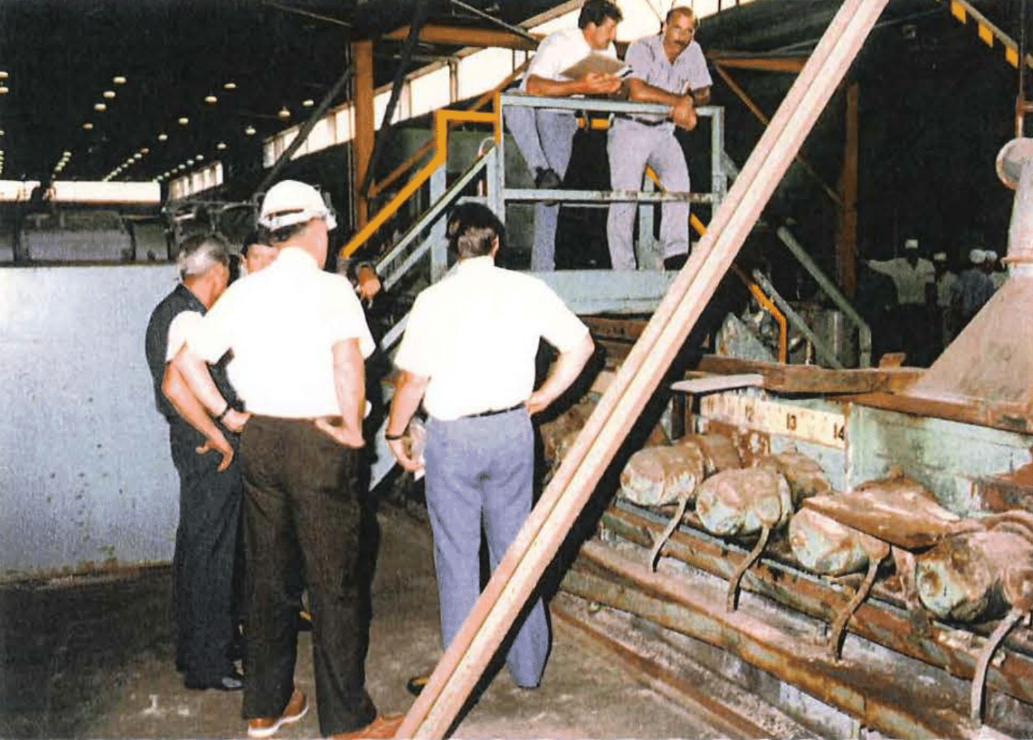 Workers stand near the salt vat inside of Plant 6 at the Fernald Feed Material Production Center after it was drained following the disappearance of employee David Bocks in June 1984.