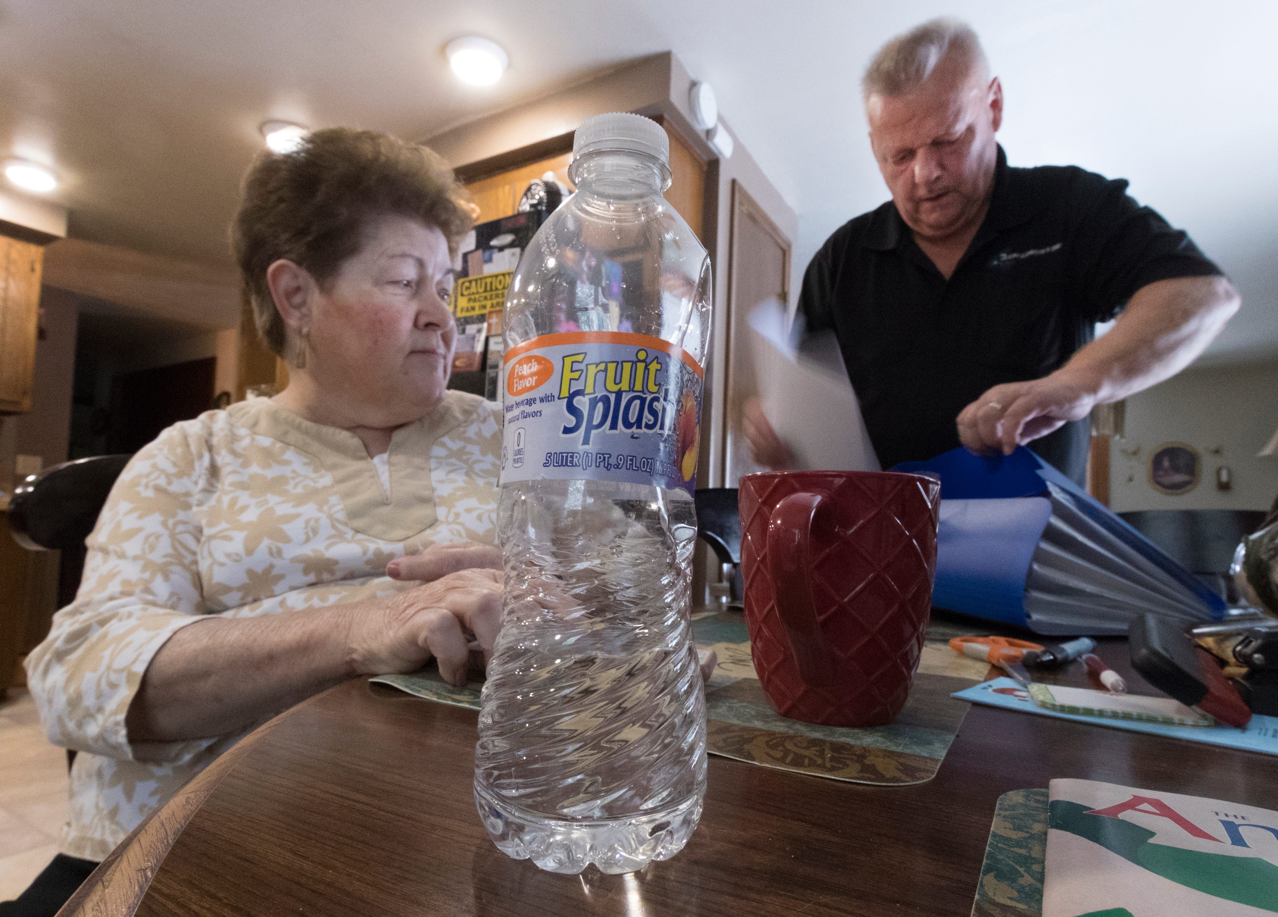 Mary Lou and Arlin Karnopp look through test results of their private well. They are pressing regulators to address drinking water contamination in Kewaunee County.