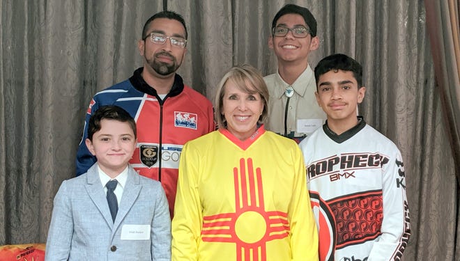 Pictured with Governor Michelle Lujan Grisham are, clockwise from bottom, Uriah Nordorf, James Baca, Mykal Carlos and Xavier Baca.